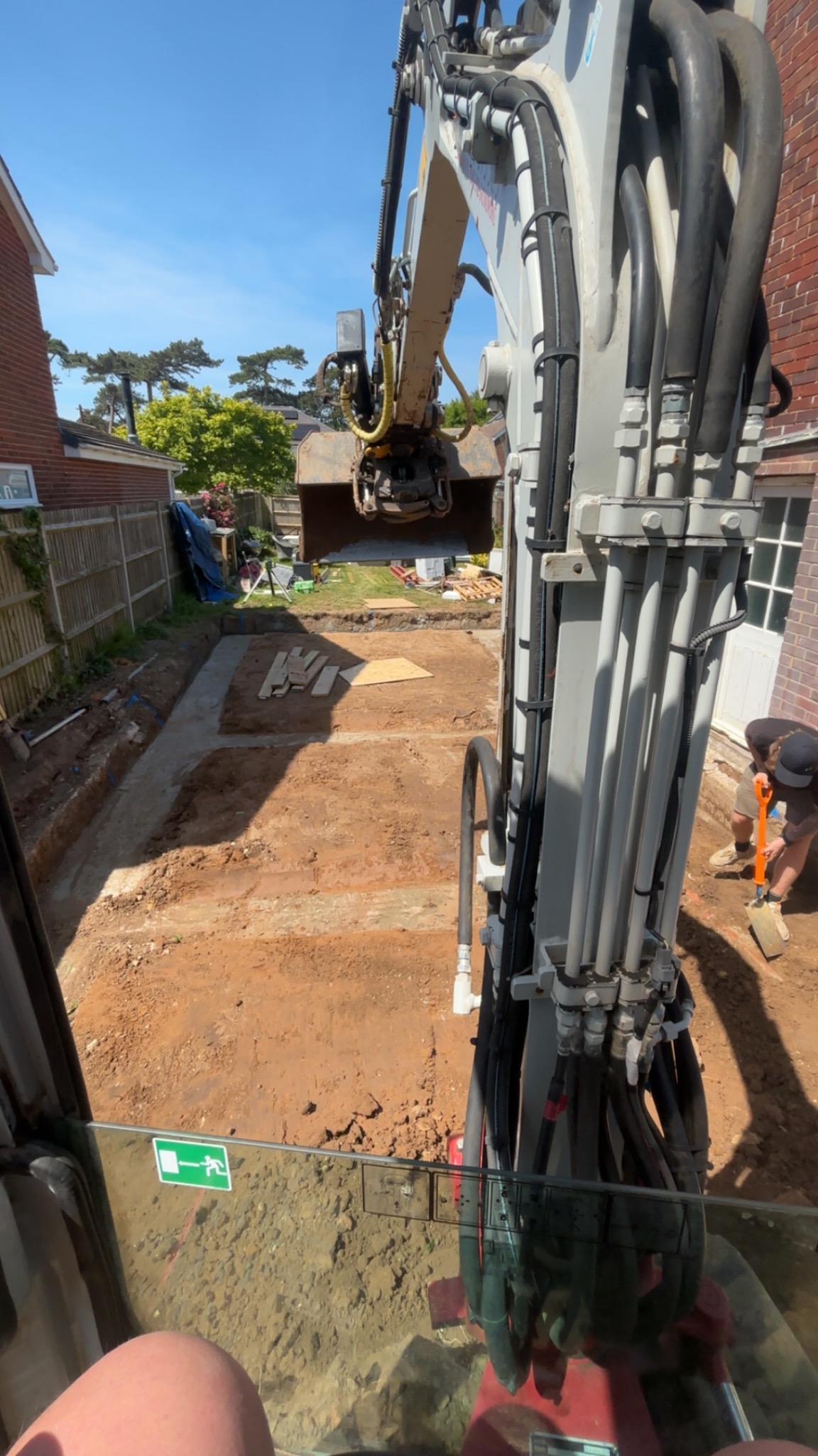 Mini excavator carrying out groundwork on a residential site