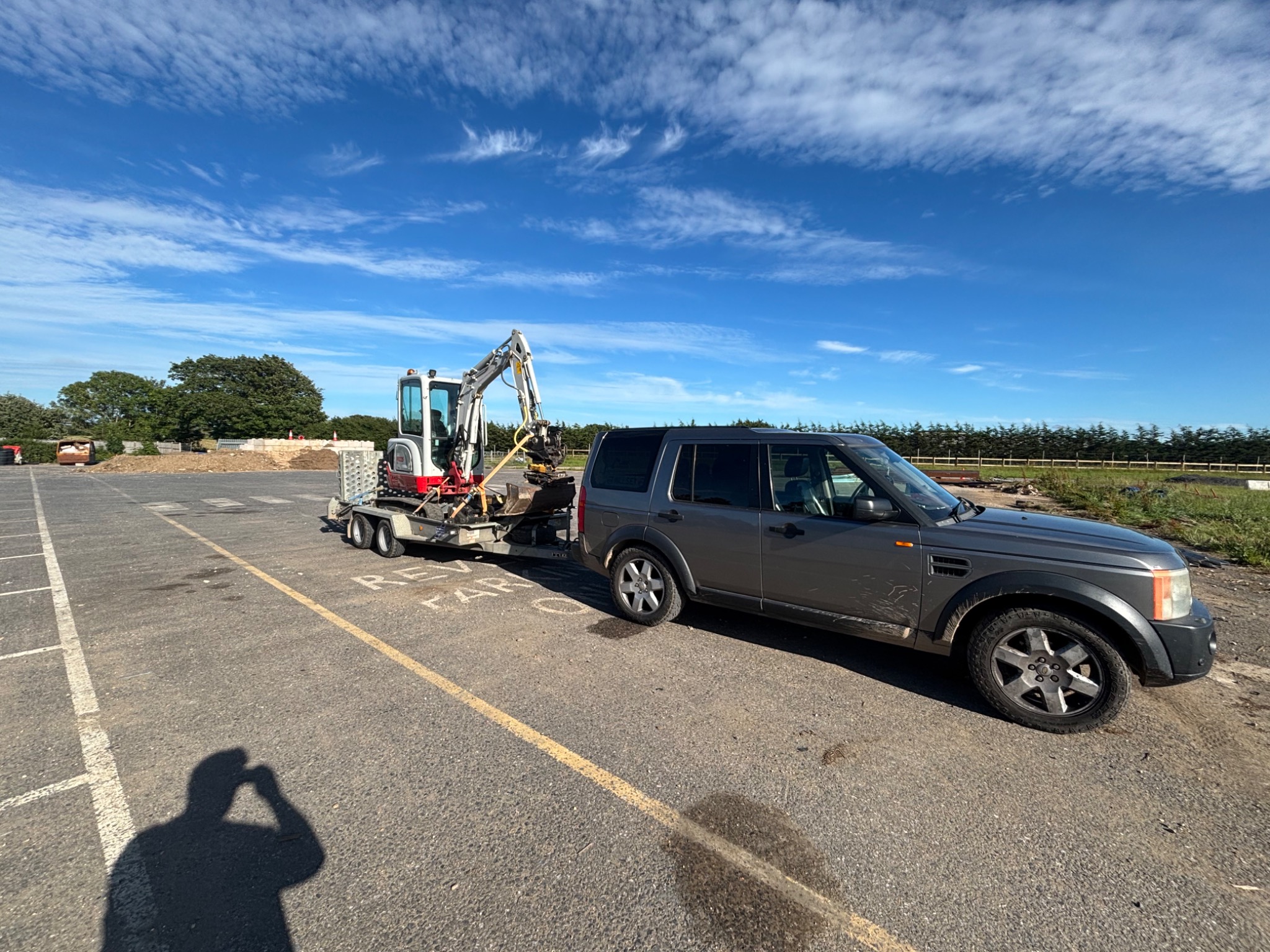 Excavator transported on trailer to a work site