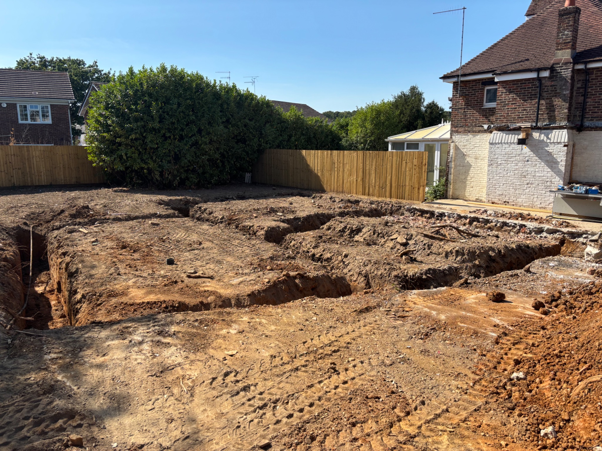 Foundation trenches excavated beside a house
