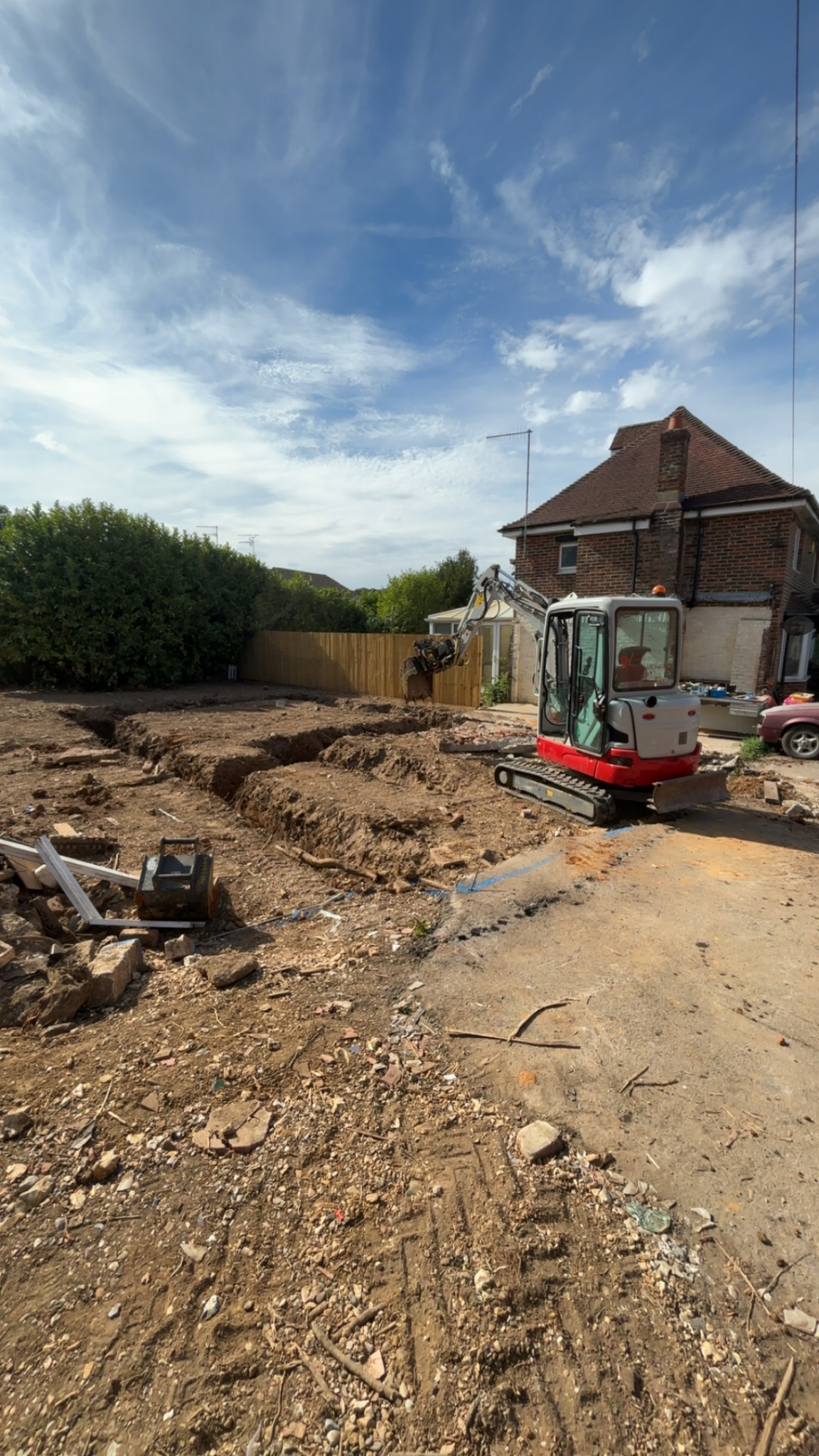 Mini excavator working on foundation trenches